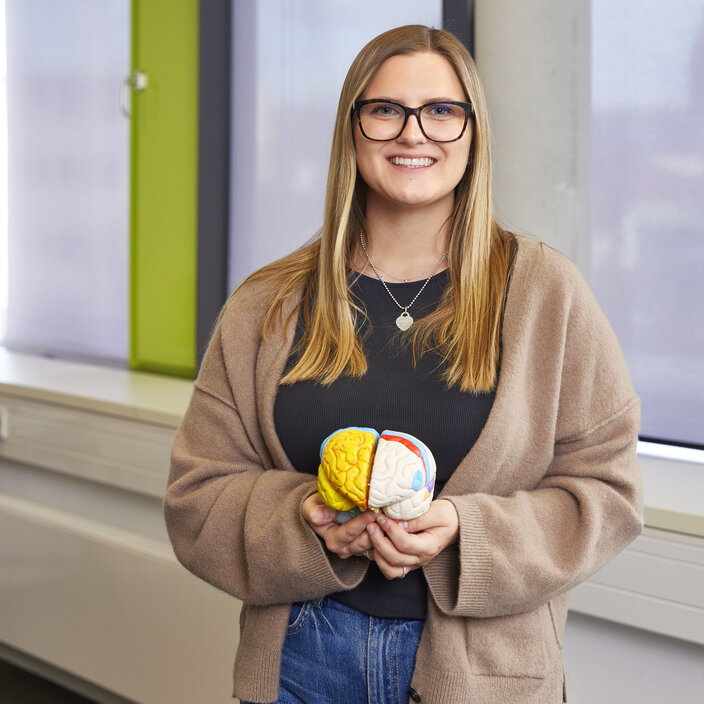 Emely Höpken from Germany Portrait of Emely Höpken holding a model of a brain